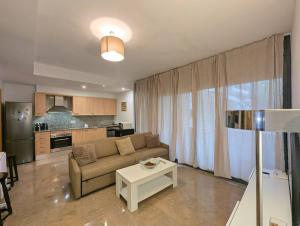 a living room with a couch and a table at Relax en Lloret con Gym y Piscina by Host&Joy in Lloret de Mar