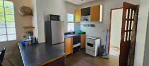 a kitchen with a refrigerator and a stove top oven at GREEN House in Vila Praia Do Bilene