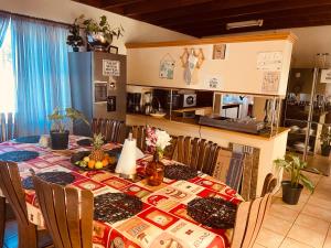 a dining room with a table and a kitchen at Zagorski’s Bed and breakfast in Bloubergstrand