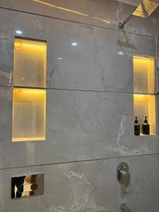 a bathroom with a marble shower with two windows at Shri Radha Krishnam in Barsāna +25 photos