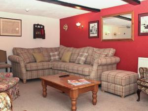 a living room with two couches and a table at Churchview House in Winterborne Abbas