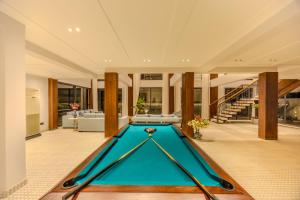 a pool table in the middle of a living room at Valley View 5-BHK Villa With Private Pool, Sit-out Areas, TT Table, Pool Table , Bar & Scenic Views in Mapusa