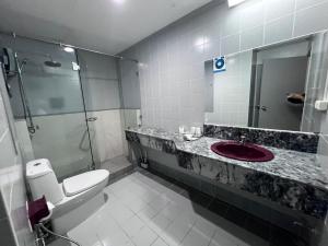 a bathroom with a sink and a toilet and a shower at Patong Beachfront Tower 30 Floor Penthouse in Patong Beach +15 photos