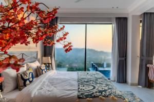 a bedroom with a bed and a large window at Valley View 5-BHK Villa With Private Pool, Sit-out Areas, TT Table, Pool Table , Bar & Scenic Views in Mapusa +129 photos