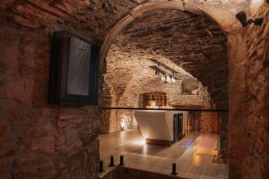 a kitchen with an archway in a brick wall at DOMA u nás Boutique hotel & spa in Poprad +119 photos