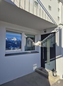 a house with a balcony with a view of a mountain at Apartment am Egghof Deluxe in Oberperfuss