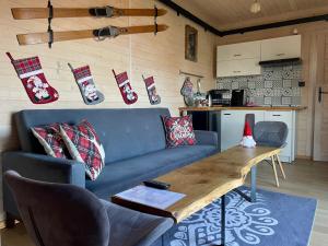 a living room with a blue couch and a wooden table at Somnium Pieniny in Tylka +76 photos