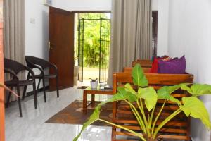 a living room with a couch and a table at Sunils Inn Bentota in Bentota