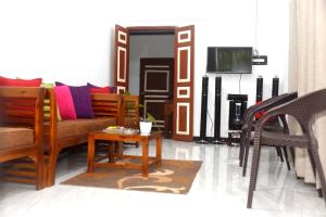 a living room with a couch and a table at Sunils Inn Bentota in Bentota