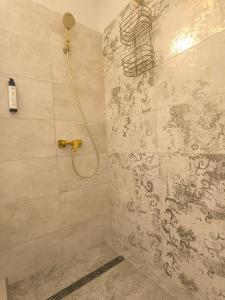 a bathroom with a shower with a mural on the wall at GrandPa Delux in Miskolc