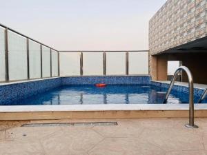 a swimming pool with a red frisbee in it at فندق ليان بارك Lian Park Hotel in Al Khobar