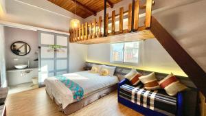 a bedroom with a bed and a couch in it at 安平156民宿 in Tainan