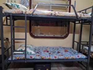 two bunk beds in a room with a mirror at MSVNATIVE HOME Stay Near Airport in Chennai