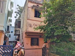 a man standing in front of a building at MSVNATIVE HOME Stay Near Airport in Chennai
