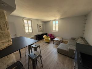 un salon avec un canapé, une table et des chaises dans l'établissement New - Charming apartment - historic heart, à Montpellier