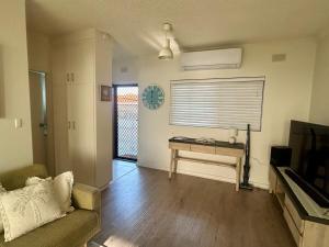 a living room with a couch and a table at The Seaview at Semaphore Park in Port Adelaide