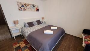 a bedroom with a bed with two towels on it at Marina Cottage in Enying