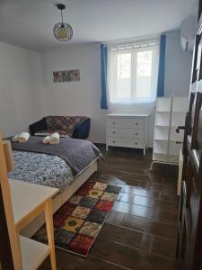 a bedroom with a bed and a table and window at Marina Cottage in Enying