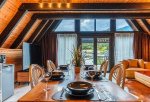 a dining room with a table with wine glasses at Camping Bansko "Between the Mountains" in Bansko