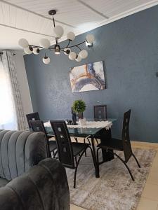 a dining room with a table and chairs at Greenstar villa homes in Kisii +3 photos