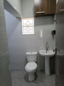 a bathroom with a toilet and a sink at Greenstar villa homes in Kisii