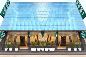 a rendering of a building with potted plants in front at Hotel Ginger Palace Delhi Airport in New Delhi