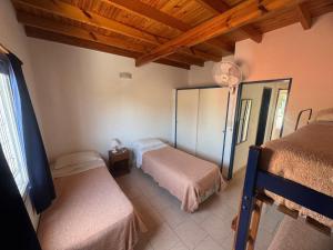 En eller flere senge i et værelse på Complejo Hueney Departamentos