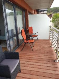 a porch with chairs and a table on a balcony at Triventi Mountain Residence Apartament Miętowy Zakątek in Karpacz