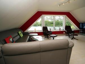 a living room with a couch and some chairs at Apartment house at Kiessee, Westerholt in Westerholt