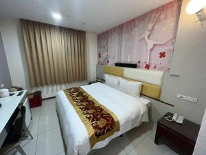 Ένα ή περισσότερα κρεβάτια σε δωμάτιο στο TC Hotel