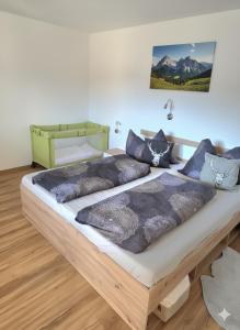 a bedroom with a large bed with blue pillows at Apartment am Egghof Deluxe in Oberperfuss