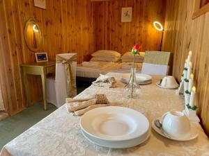 a room with a table with plates on it at K&B Residence in Jarosław +56 photos