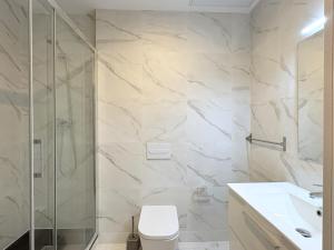 a bathroom with a shower and a toilet and a sink at lullaby by hamilton in Barcelona +37 photos