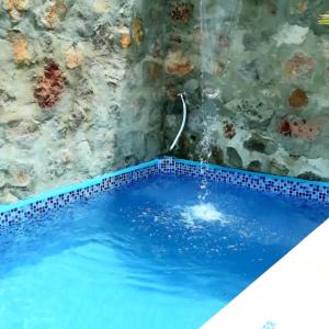 a swimming pool in a bathroom with a tile wall at Um castelo só pra você! 