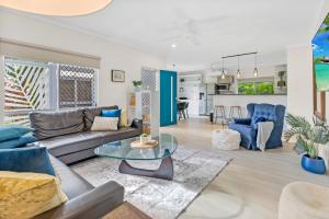a living room with a couch and a table at Eden House Kewarra Beach in Kewarra Beach