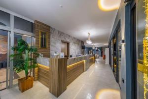 a lobby with a bar with a potted plant at HanzadeHotel in Edremit