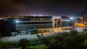 a large building at night with lights on at HanzadeHotel in Edremit