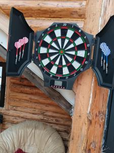 a dart board hanging from a ceiling with darts at Casuta Verde in Gura Humorului