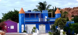 a blue house with orange turrets on top at Um castelo só pra você! 