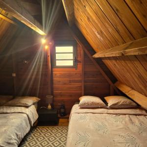 a bedroom with two beds in a wooden cabin at Bienvenue chez Gaston in Le Tampon