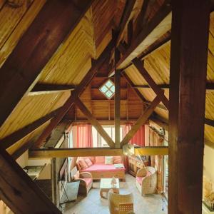 an attic view of a living room with wooden ceilings at Bienvenue chez Gaston in Le Tampon +2 photos