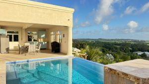 a house with a swimming pool next to a house at Amaro Villas 1246 Barbados 231 Feel like when you're home 1839 in Saint Thomas