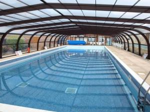 a large swimming pool with an open structure at 30 Waterside in Corton