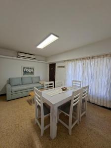 a living room with a table and chairs and a couch at Los Dias de Viaje in Tandil