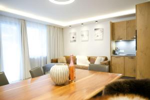 a room with a table with a bottle on it at NĀVA PLACE Cozy home in Kaprun in Kaprun +7 photos