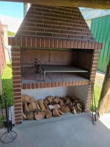 a brick oven with a pile of fire wood at UNSER TRAUM in Concordia