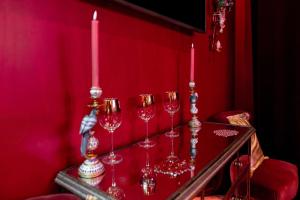 a group of wine glasses on a table with candles at Suite Jacuzzi & Sauna privatifs - Paris - Or Norme By Le Douze in Paris
