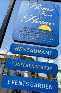 a group of signs on the side of a restaurant at Home from Home Ghana in Accra
