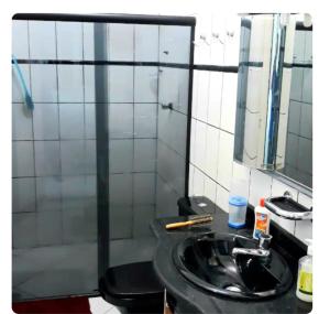 a bathroom with a black sink and a mirror at Um castelo só pra você!  +52 photos