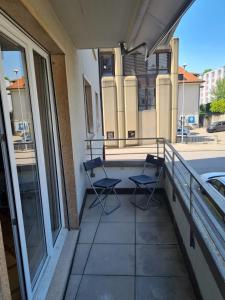 two chairs sitting on the balcony of a building at Private Ideal Apartment in Fribourg